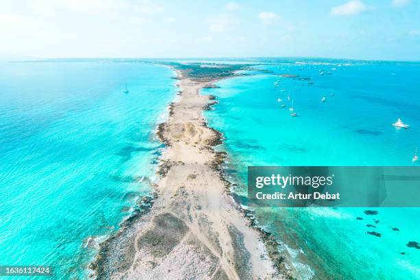 aerial view by drone above the paradise island of formentera in spain with narrow land and turquoise beach water. - insel formentera stock-fotos und bilder
