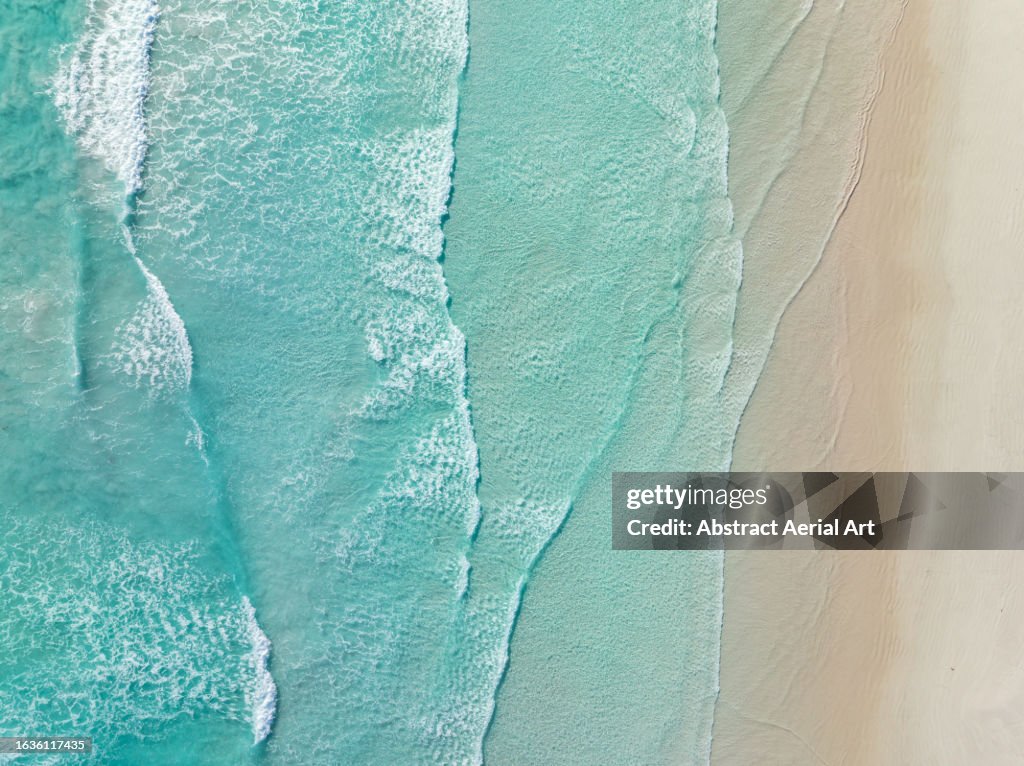 Waves from the Southern Ocean washing onto a beach shot from a drone perspective, Esperance, Western Australia, Australia