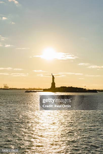 the statue of liberty in new york city .beautiful hudson river landscape at sunset,nyc usa - new york liberty center stock pictures, royalty-free photos & images