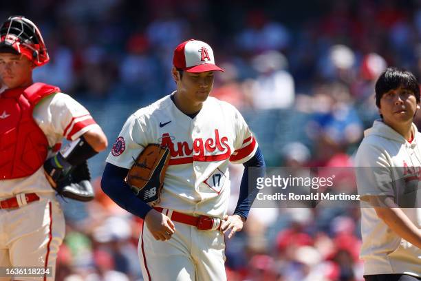 Shohei Ohtani of the Los Angeles Angels leaves the game against the Cincinnati Reds in the second inning during game one of a doubleheader at Angel...