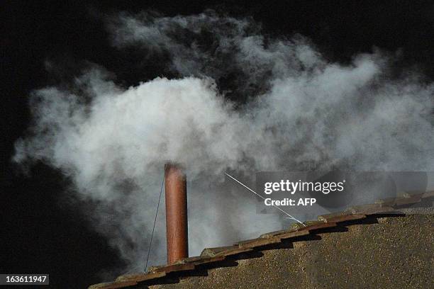 White smoke rises from the chimney on the roof of the Sistine Chapel meaning that cardinals elected a new pope on the second day of their secret...