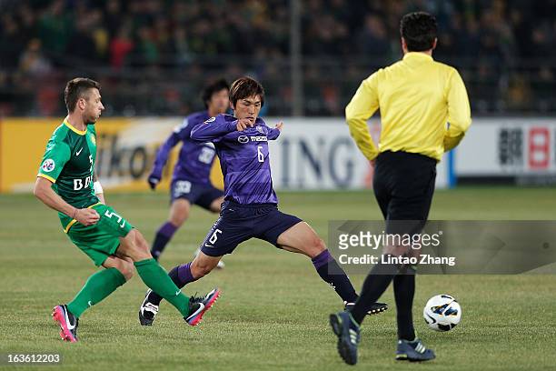 Darko Matic of Beijing Guo'an challenges Toshihiro Aoyama of Hiroshima Sanfrecce during the AFC Champions League Group match between Hiroshima...