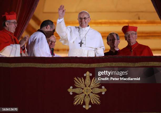 Newly elected Pope Francis I waves to the waiting crowd from the central balcony of St Peter's Basilica on March 13, 2013 in Vatican City, Vatican....