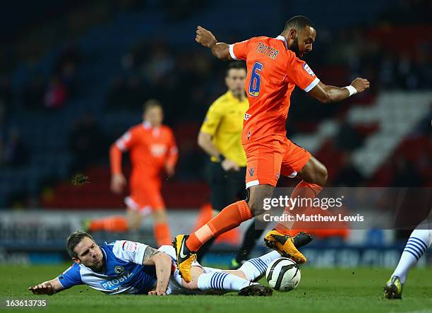 Liam Trotter of Millwall hurdles the tackle of David Dunn of Blackburn Rovers during the FA Cup sponsored by Budweiser Sixth Round Replay match...