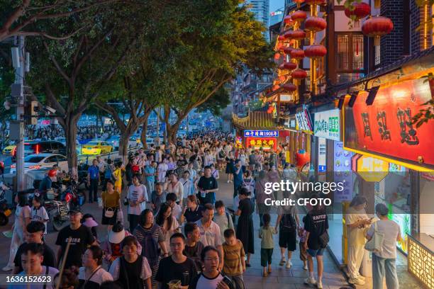 Tourists flock to Hongya Cave scenic spot in Chongqing, China, Aug. 15, 2023. According to the latest data from the China Tourism Academy, the number...