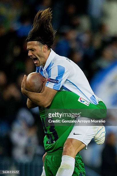 Martin Demichelis of Malaga CF celebrates their first goal scored by his teammate Isco with goalkeeper Wilfredo Caballero during the UEFA Champions...