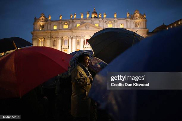 Man stands in front of St Peter's Basilica in St. Peter's Square after white smoke billowed out of the chimney signifying that the Cardinals in the...