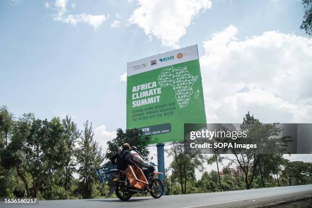 Motorcyclist rides past a poster detailing the upcoming Africa Climate Summit scheduled for September 4th to 6th in Nairobi. The inaugural Africa...