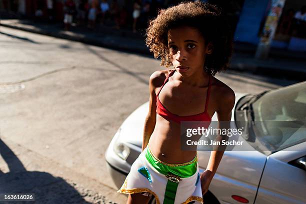 Brazilian girl, wearing a colorful skirt, takes part in the Carnival parade in the favela of Rocinha, on 20 February 2012 in Rio de Janeiro, Brazil....