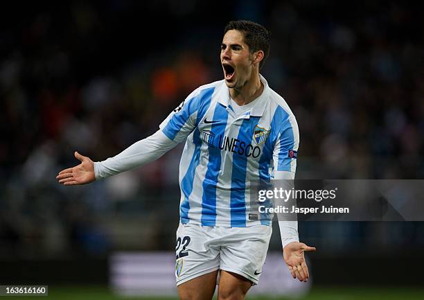 Isco of Malaga CF celebrates scoring his sides opening goal during the UEFA Champions League Round of 16 second leg match between Malaga CF and FC...