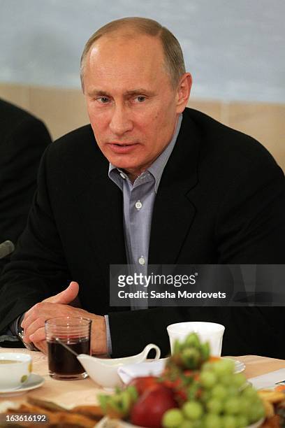 Russian President Vladimir Putin speaks while visiting Sambo-70, a Russian martial art and combat sport school, March 13, 2013 in Moscow, Russia....
