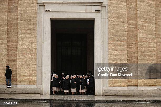 Group of nuns wait for a bus in heavy rain on March 13, 2013 in Vatican City, Vatican. Argentinian Cardinal Jorge Mario Bergoglio was later elected...