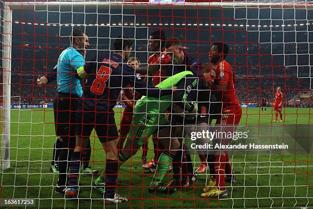 Manuel Neuer , keeper of Muenchen safes the ball against Laurent Koscienly of Arsenal after he scores the 2nd team goal during the UEFA Champions...