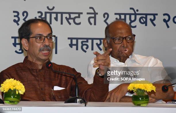 Shiv Sena chief Uddhav Thackeray gestures with his hand as Nationalist Congress Party chief Sharad Govindrao Pawar looks on during the Maha Vikas...