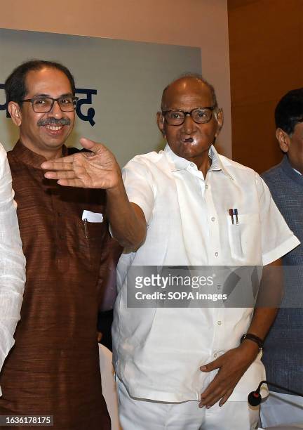 Shiv Sena chief Uddhav Thackeray pose for a photo with Nationalist Congress Party chief Sharad Govindrao Pawar after the Maha Vikas Aghadi press...