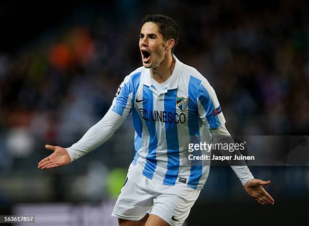 Isco of Malaga CF celebrates scoring his sides opening goal during the UEFA Champions League Round of 16 second leg match between Malaga CF and FC...