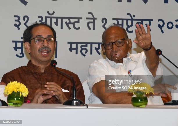 Shiv Sena chief Uddhav Thackeray looks on as Nationalist Congress Party chief Sharad Govindrao Pawar gestures with his hand during the Maha Vikas...