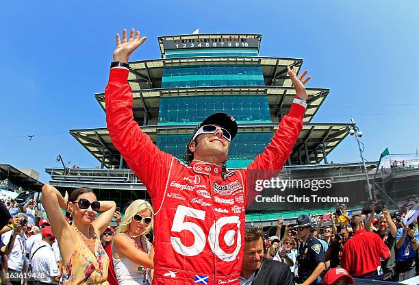 Dario Franchitti of Scotland, driver of the Target Chip Ganassi Racing Honda celebrates wife Ashley Judd and Susie Wheldon , wife of the late Dan...