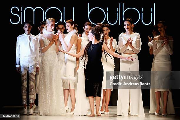 Fashion designer Simay Bulbul on the runway with models after her show during Mercedes-Benz Fashion Week Istanbul Fall/Winter 2013/14 at Antrepo 3 on...