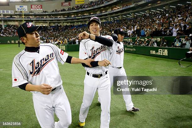 Kenta Maeda of Team Japan celebrates with teammates after winning Pool 1, Game 6 between the Netherlands and Japan in the second round of the 2013...