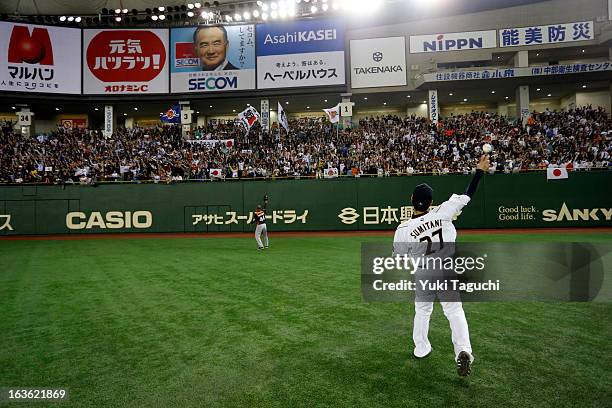 Ginjiro Sumitani of Team Japan tosses an autographed ball into the stands during Pool 1, Game 6 between the Netherlands and Japan in the second round...