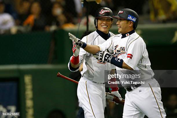 Shinosuke Abe celebrates with Yoshio Itoi after hitting a home run in the second inning during Pool 1, Game 6 between the Netherlands and Japan in...