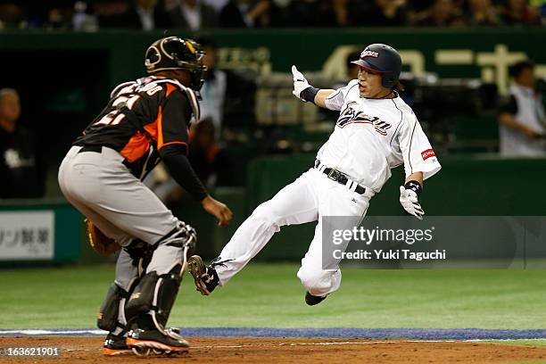 Nobuhiro Matsuda slides safely into home in the bottom of the second inning during Pool 1, Game 6 between the Netherlands and Japan in the second...