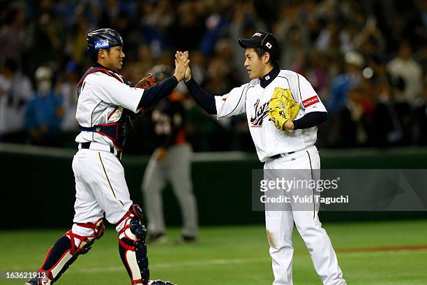 Kazuhisa Makita and Ginjiro Sumitani celebrate after winning Pool 1, Game 6 between the Netherlands and Japan in the second round of the 2013 World...