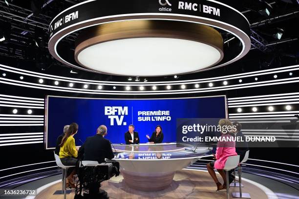 General director of French BFM TV news channel, Marc-Olivier Fogiel and BFM TV host and journalist Apolline de Malherbe speak during a broadcast...