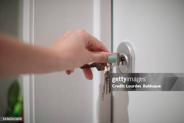 hand of woman opening door - chave imagens e fotografias de stock