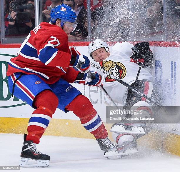 Alex Galchenyuk of the Montreal Canadiens sends Marc Methot of the Ottawa Senators hard into the boards during the NHL game on March 13, 2013 at the...