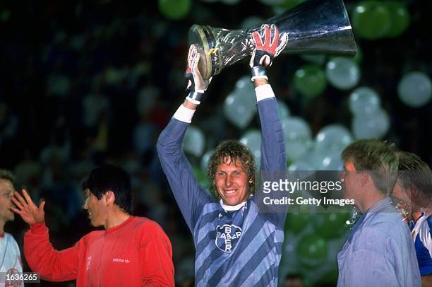 Vollborn of Bayer Leverkusen holds the trophy up in victory after the UEFA Cup Final Second Leg match against Espanol at the Ulrich Haberland Stadium...