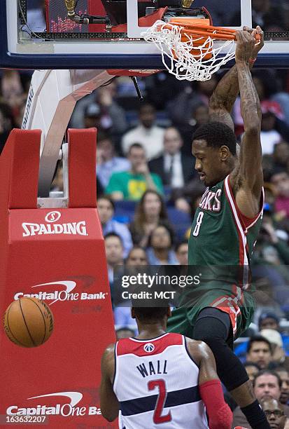 Milwaukee Bucks center Larry Sanders slam dunks over Washington Wizards point guard John Wall during the second half of their game played at the...