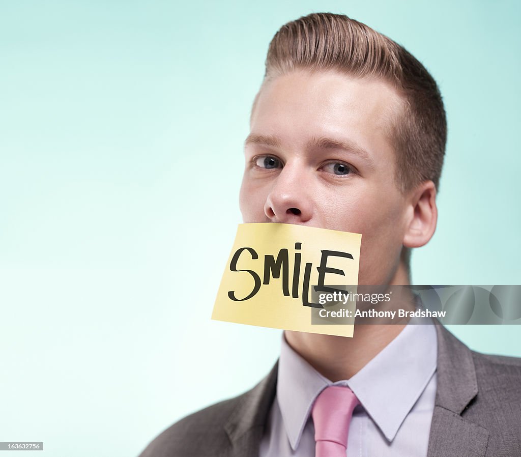 Businessman with a painted smile