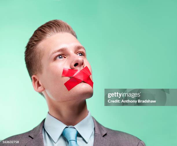 businessman with mouth sealed closed - man with tape on lips stock pictures, royalty-free photos & images