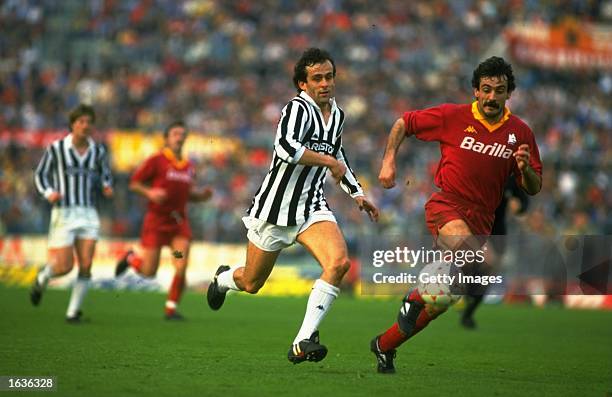 Michel Platini of Juventus chases Emidio Oddi of Roma during an Italian League match at the Olympic Stadium in Rome. Roma won the match 3-0. \...