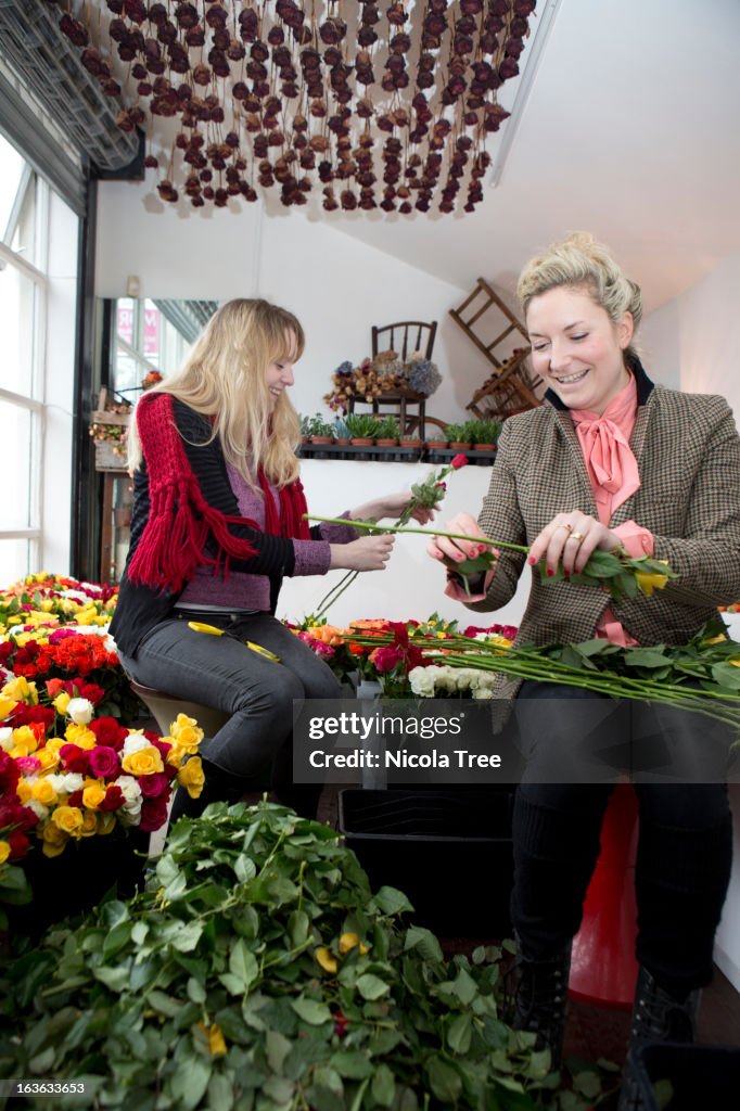 Two florists working together in a shop