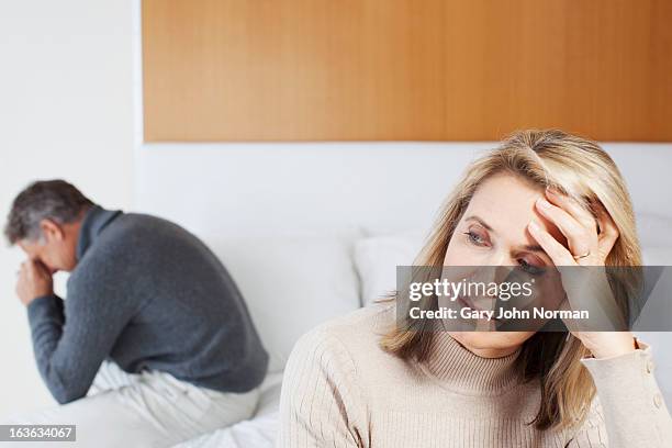 middle aged couple having a disagreement - in the dog house stockfoto's en -beelden