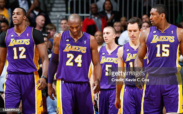 Kobe Bryant of the Los Angeles Lakers walks off the court after missing a game-tying three-point basket in the final seconds against the Atlanta...