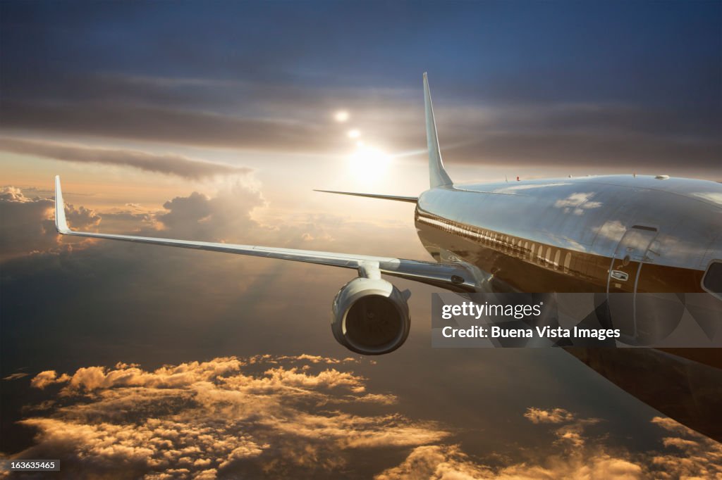 Commercial jet flying over clouds