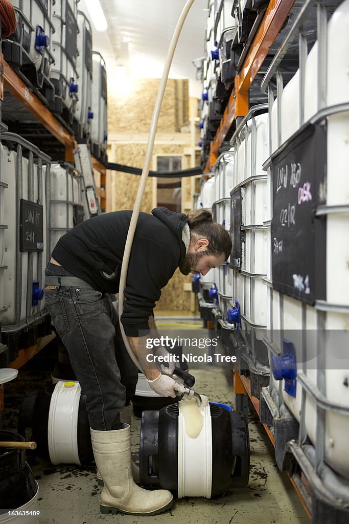 A Brewery Technician Filling A Cask With Beer High-Res Stock Photo ...