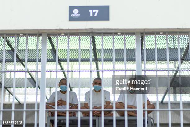 In this handout picture provided by the Salvadoran presidency Inmates remain at their cell during a humanitarian visit to counter-terrorism...