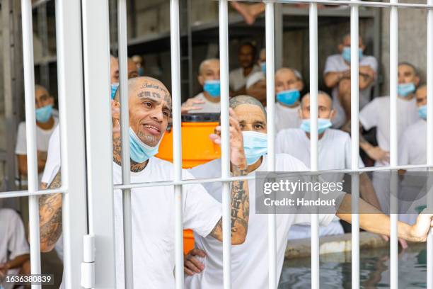 In this handout picture provided by the Salvadoran presidency Inmates remain at their cell during a humanitarian visit to counter-terrorism...