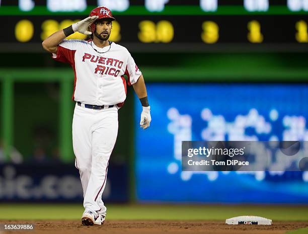 Angel Pagan of Team Puerto Rico salutes to his teammates from second base after hitting a double in Pool 2, Game 3 against Team Italy in the second...