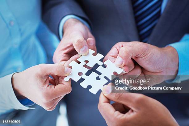 finding solutions through teamwork - four people stock pictures, royalty-free photos & images