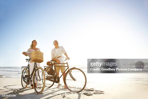 keeping themselves in great shape - bike beach stockfoto's en -beelden