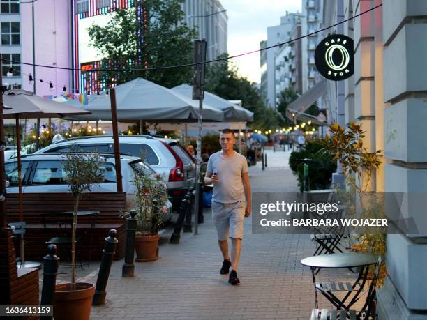 Yevgen Kuruch, 38-years-old Ukrainian reserve officer and now taxi driver, walks through a street in Warsaw, Poland, on July 31, 2023. The war of...