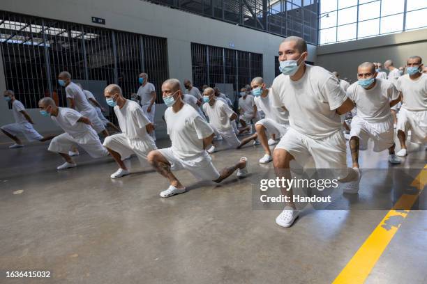 In this handout picture provided by the Salvadoran presidency Inmates exercise during a humanitarian visit to counter-terrorism confinement center...