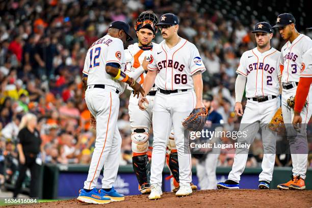 Dusty Baker Jr. #12 pulls J.P. France of the Houston Astros in the third inning against the Boston Red Sox at Minute Maid Park on August 24, 2023 in...