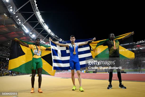 Silver medalist Wayne Pinnock of Team Jamaica, gold medalist Miltiadis Tentoglou of Team Greece and Bronze medalist Tajay Gayle of Team Jamaica pose...